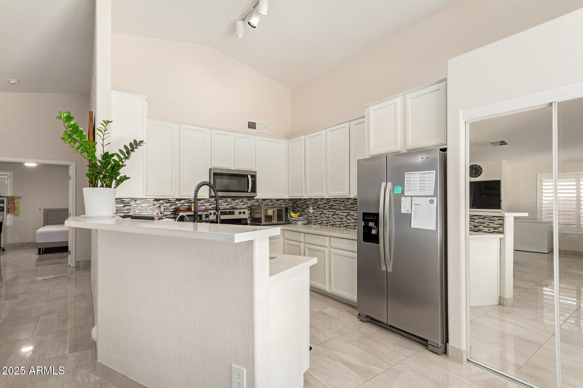 1448 North Saddle Street Gilbert, AZ 85233 - Photo 15 of 34 a kitchen with kitchen island a counter top space cabinets and stainless steel appliances