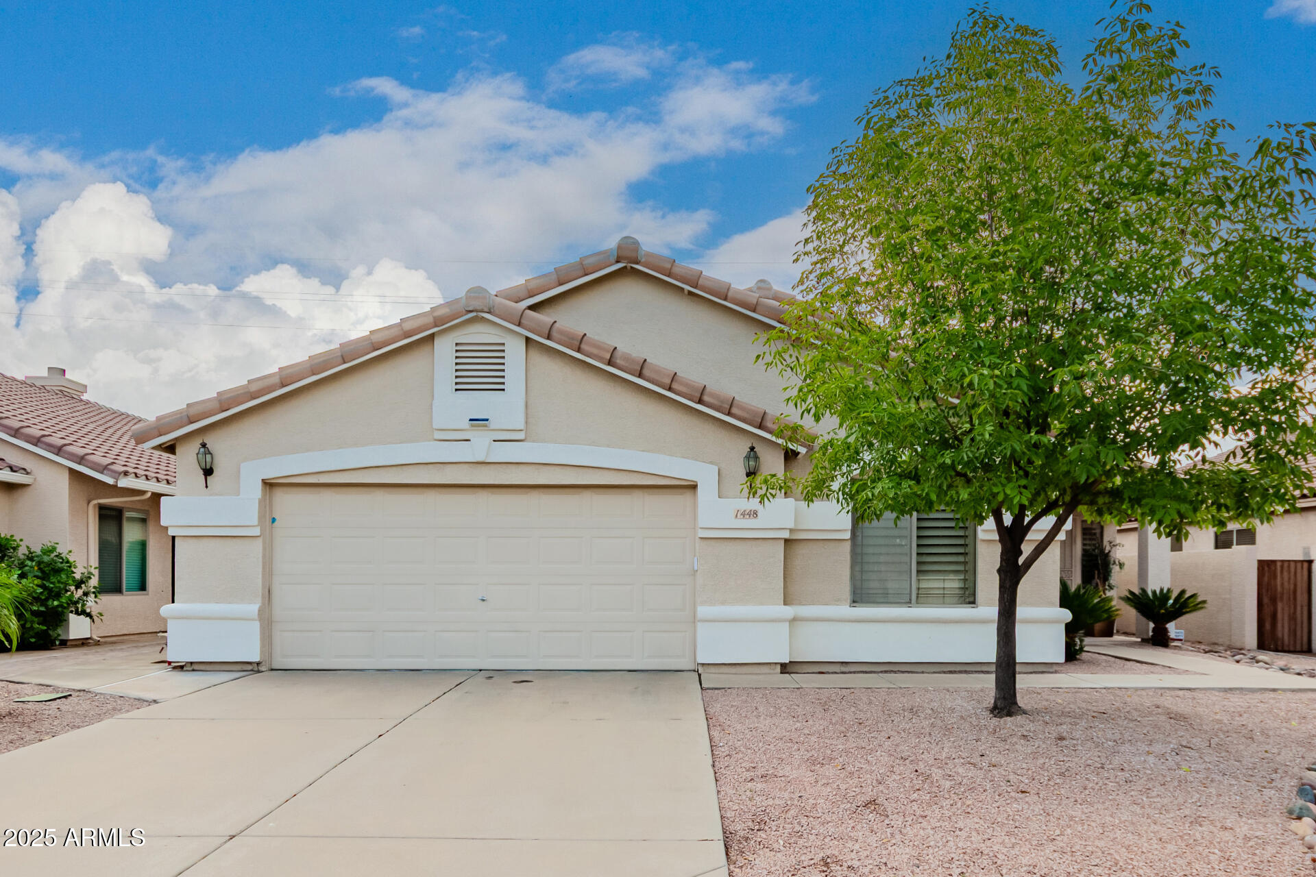 1448 North Saddle Street Gilbert, AZ 85233 - Photo 2 of 34 a front view of a house with a garage