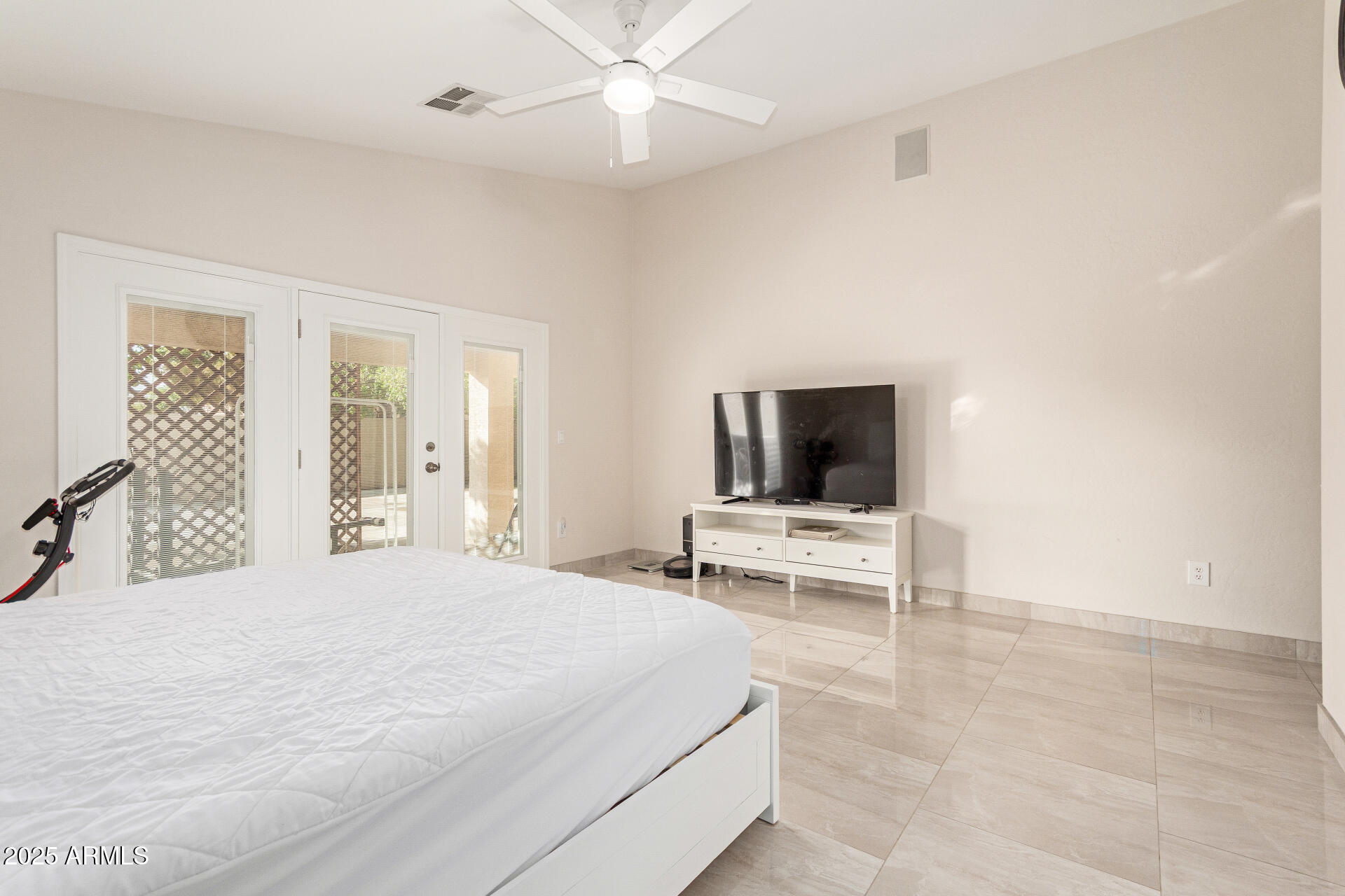 1448 North Saddle Street Gilbert, AZ 85233 - Photo 22 of 34 a bedroom with a bed and a flat screen tv