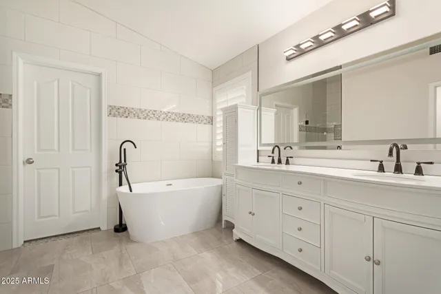a bathroom with a white bath tub and shower