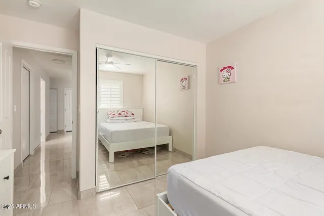 a bedroom with a bed and a desk