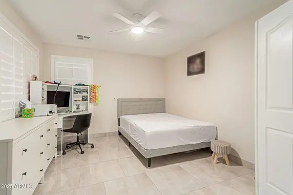 a spacious bedroom with a bed and a view of bathroom