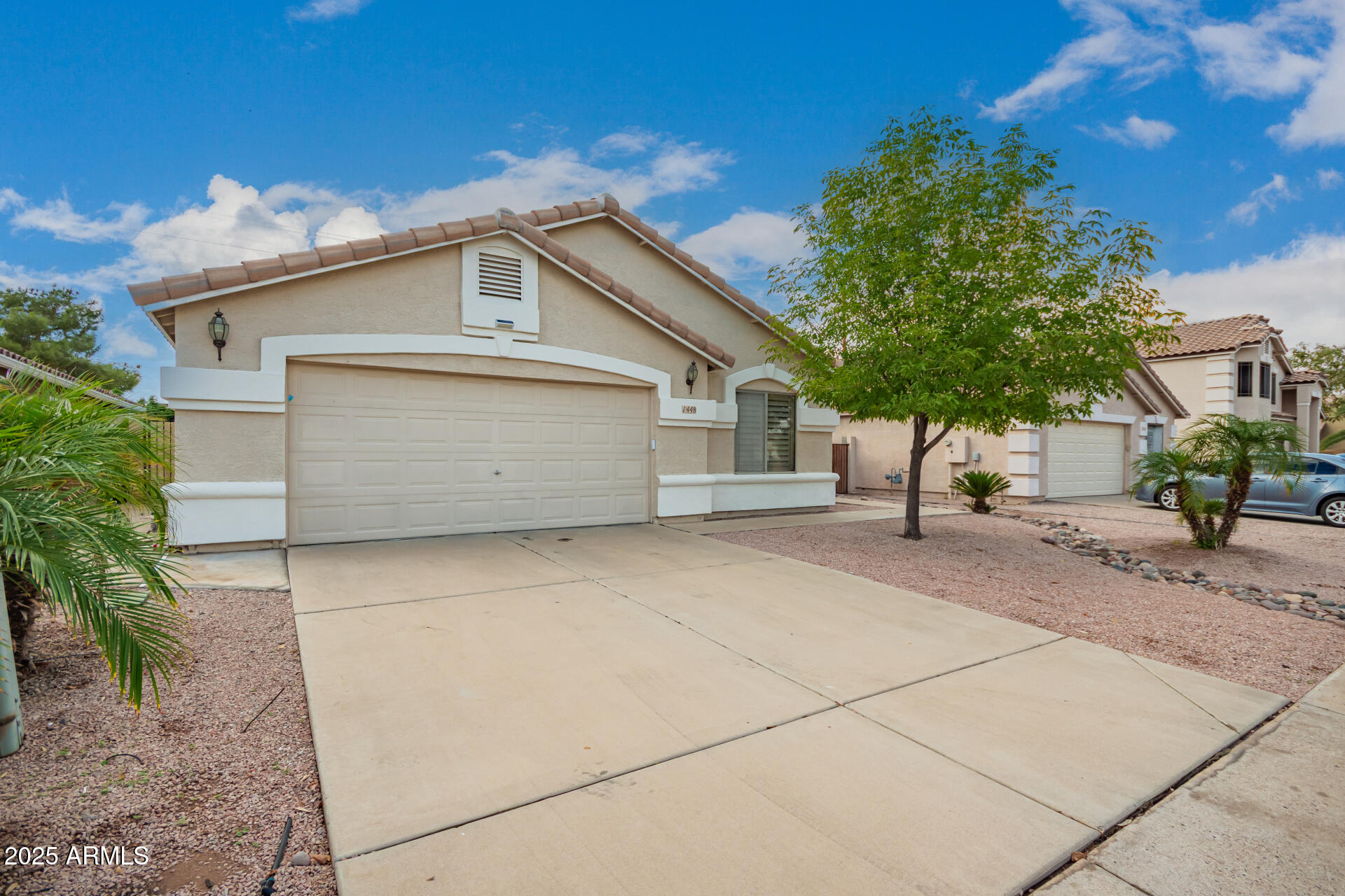 1448 North Saddle Street Gilbert, AZ 85233 - Photo 3 of 34 a front view of a house with a garage
