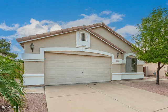 a view of a white house with a large space in front of it