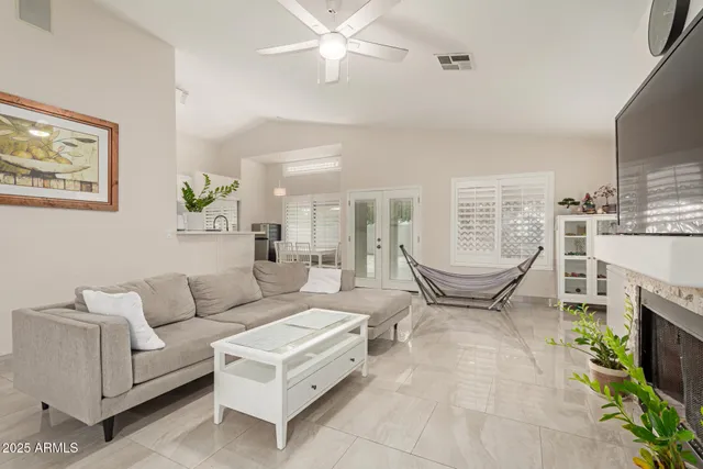 a living room with furniture a fireplace and a table