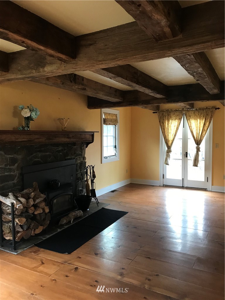 1569 North Fork Road Chehalis, WA 98532 - Photo 11 of 20 a living room with wooden floors and a fireplace