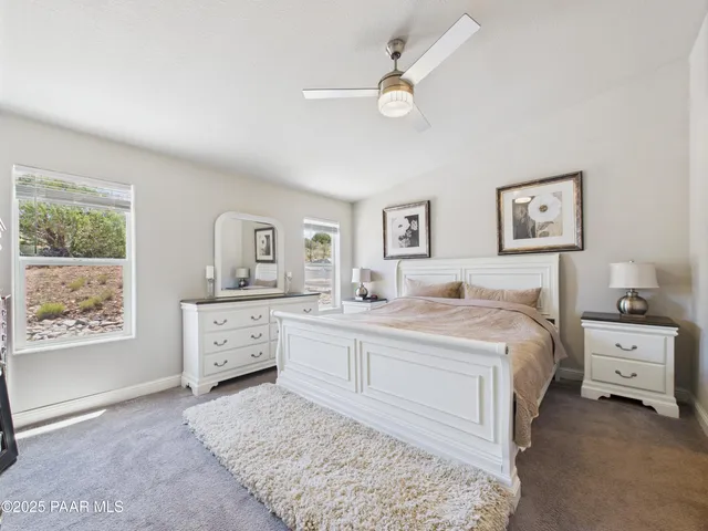 a spacious bedroom with a large bed and a window