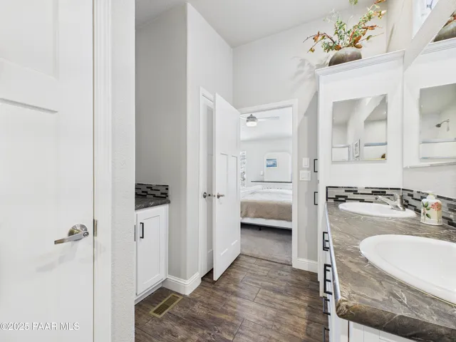 a en suite bathroom with a sink double vanity and a mirror