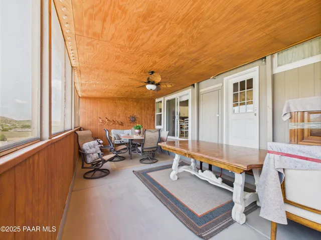 a living room with furniture pool table and a large window