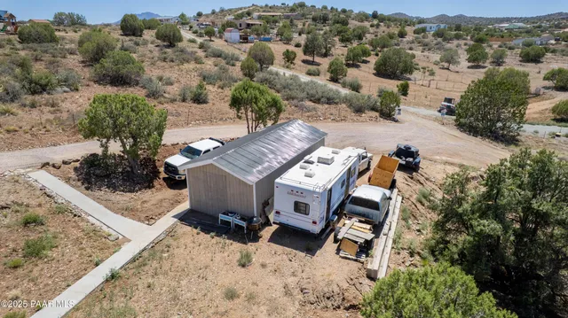 an aerial view of a house with a yard