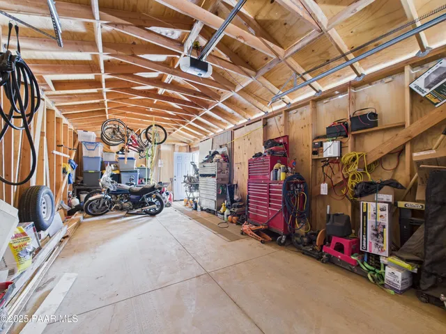a view of a garage with rack and bicycle