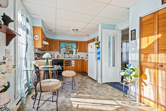 a room with stainless steel appliances kitchen island granite countertop furniture and a window