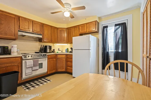 a kitchen with a refrigerator a stove a sink dishwasher and cabinets with wooden floor