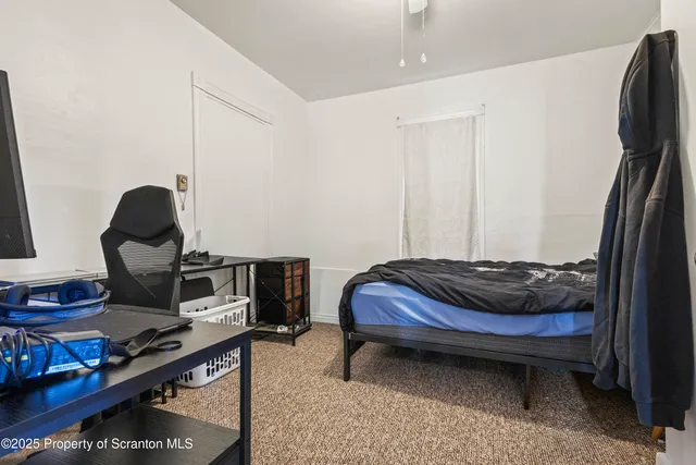 a bedroom with a bed and a desk
