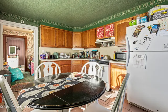 a bed sitting in a kitchen next to a window