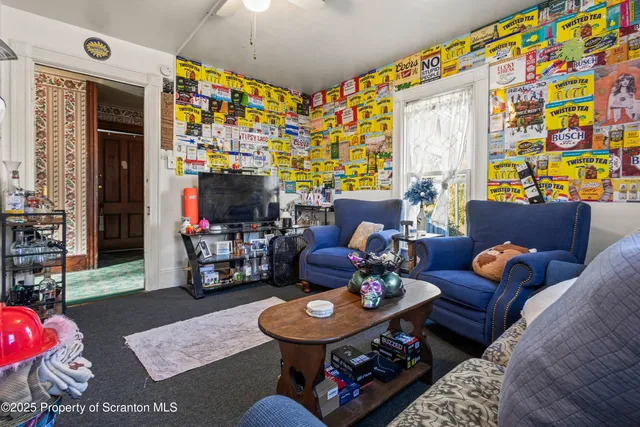 a living room with furniture and a flat screen tv