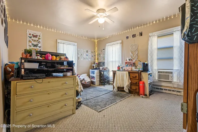 a bed room with furniture and a mirror