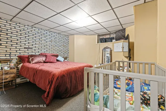 a bedroom with a bed next to a window