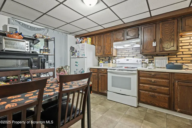 a kitchen with a stove a sink and a refrigerator