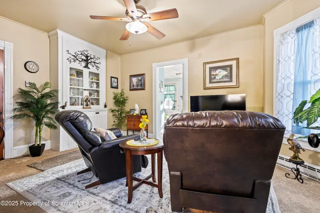 a living room with furniture potted plant and a window