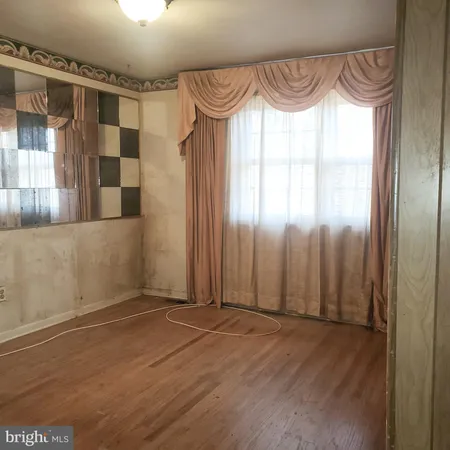 a view of a room with wooden floor and windows