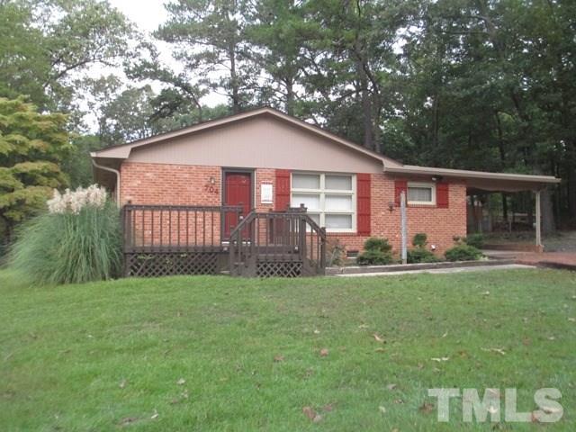 704 Cooper Road Raleigh, NC 27610 - Photo 1 of 25 a front view of a house with a yard and porch