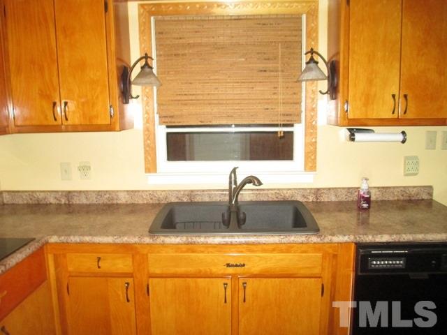 704 Cooper Road Raleigh, NC 27610 - Photo 11 of 25 a kitchen with stainless steel appliances granite countertop a sink and a window