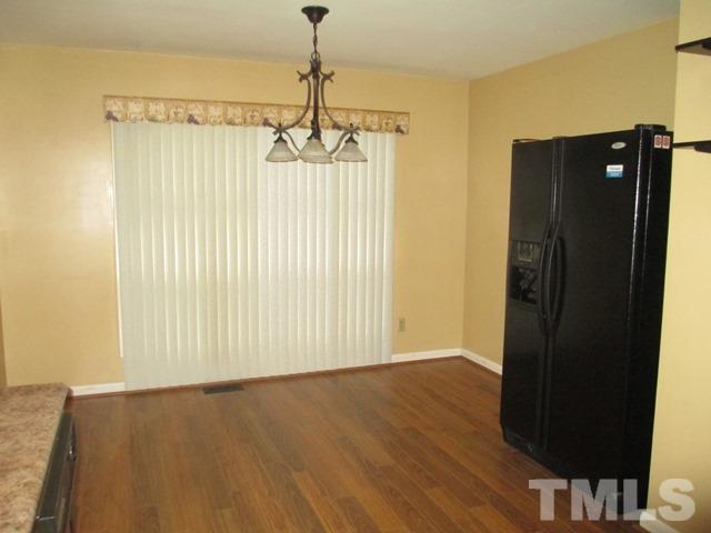 704 Cooper Road Raleigh, NC 27610 - Photo 14 of 25 a view of a hallway with wooden floor and stairs