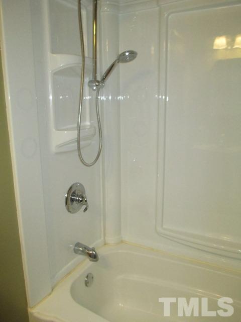 704 Cooper Road Raleigh, NC 27610 - Photo 16 of 25 a bathroom with a bath tub
