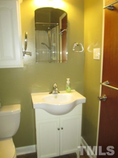 704 Cooper Road Raleigh, NC 27610 - Photo 17 of 25 a bathroom with a sink and mirror with toilet