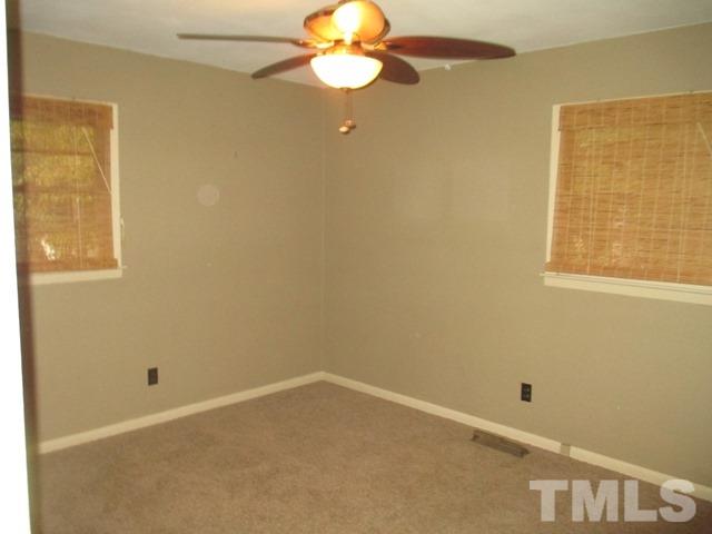 704 Cooper Road Raleigh, NC 27610 - Photo 18 of 25 an empty room with a window