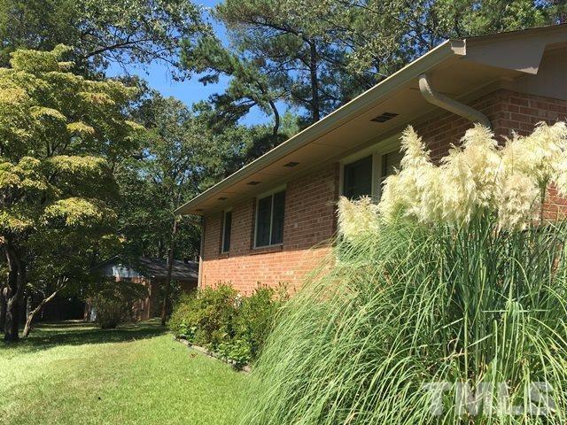 704 Cooper Road Raleigh, NC 27610 - Photo 25 of 25 a backyard of a house with lots of green space