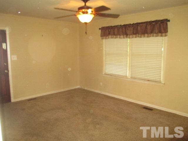 704 Cooper Road Raleigh, NC 27610 - Photo 4 of 25 a view of an empty room with a window