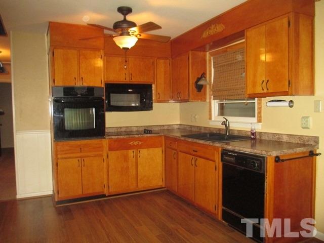 704 Cooper Road Raleigh, NC 27610 - Photo 6 of 25 a kitchen with stainless steel appliances granite countertop wooden cabinets and a granite counter tops