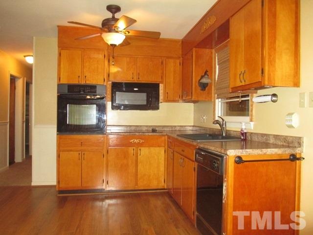 704 Cooper Road Raleigh, NC 27610 - Photo 9 of 25 a kitchen with stainless steel appliances granite countertop a stove a sink and a microwave