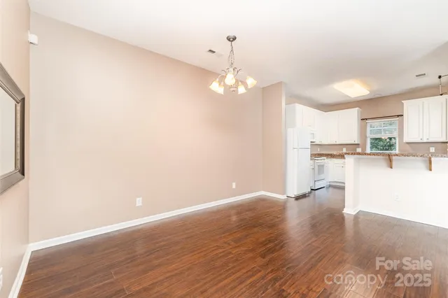 a view of a kitchen with wooden floor and a kitchen