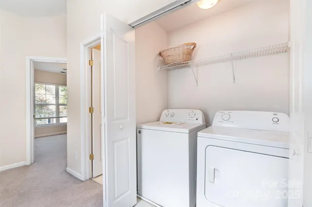 a view of storage and utility room with washer and dryer