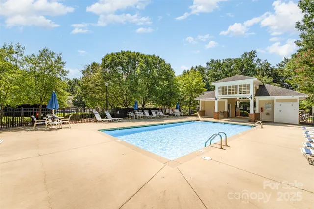 a view of a house with swimming pool and sitting area