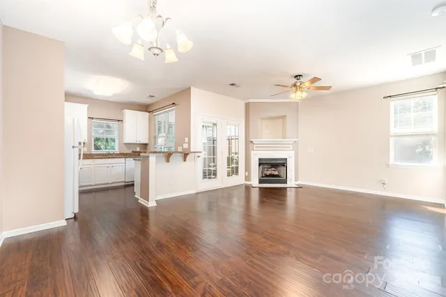 a view of a kitchen with wooden floor and a kitchen
