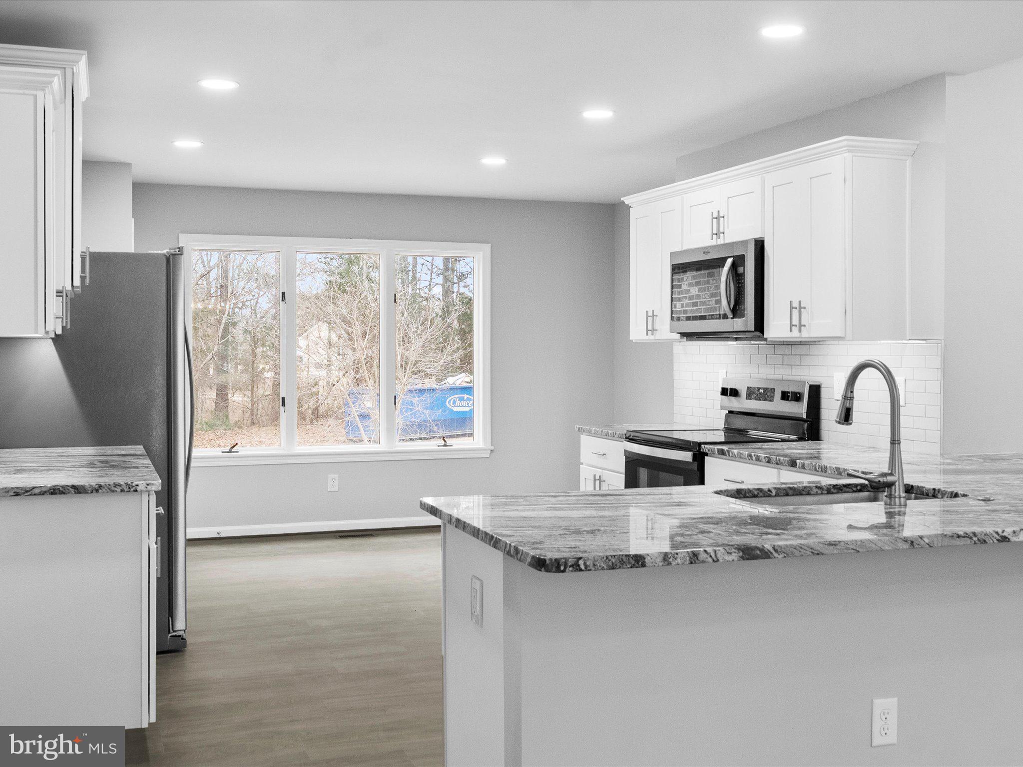 10009 River Road Petersburg, VA 23803 - Photo 17 of 59 a kitchen with stainless steel appliances granite countertop a sink a stove and a granite counter top