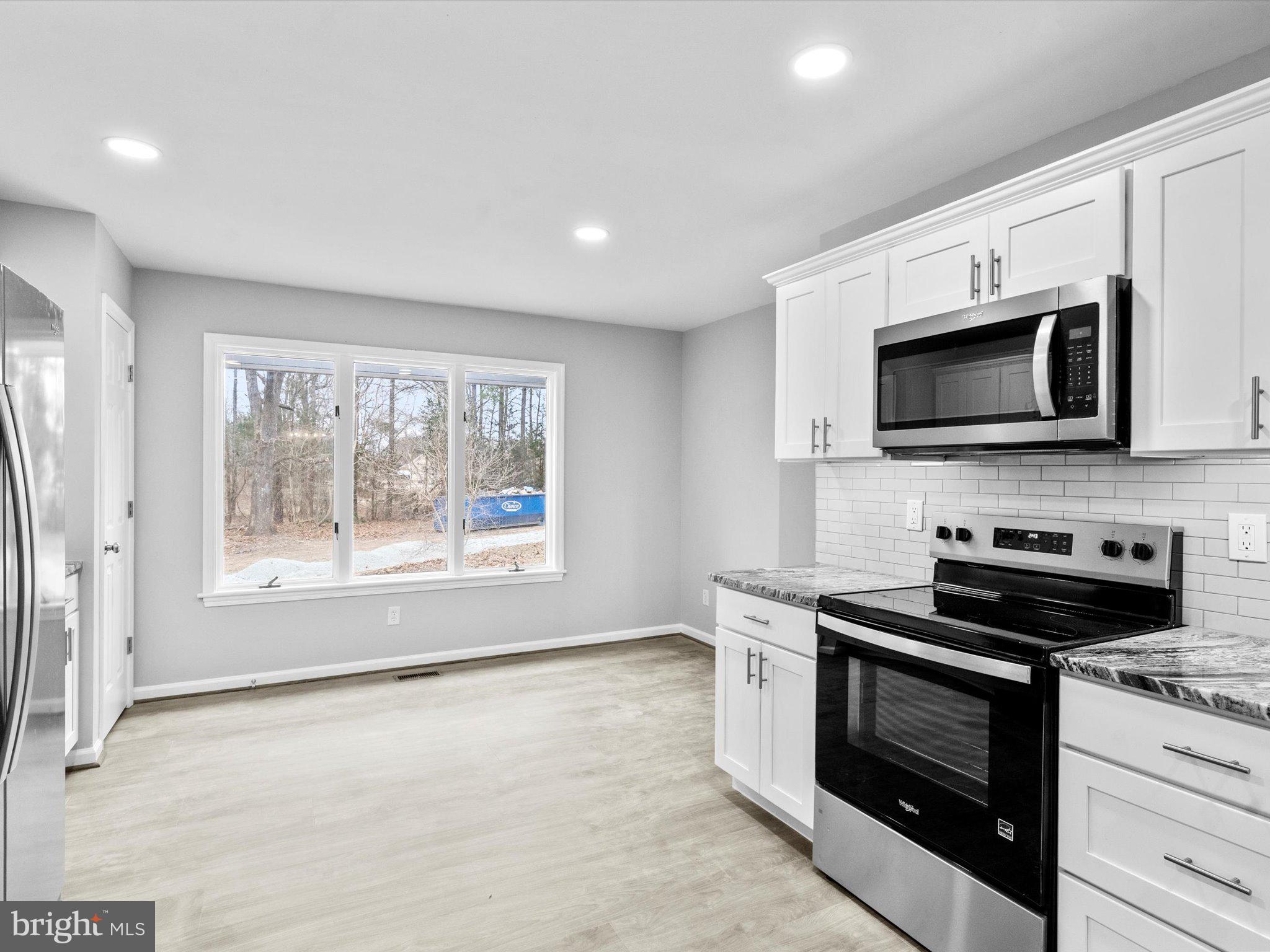 10009 River Road Petersburg, VA 23803 - Photo 19 of 59 a kitchen with stainless steel appliances a stove sink and microwave