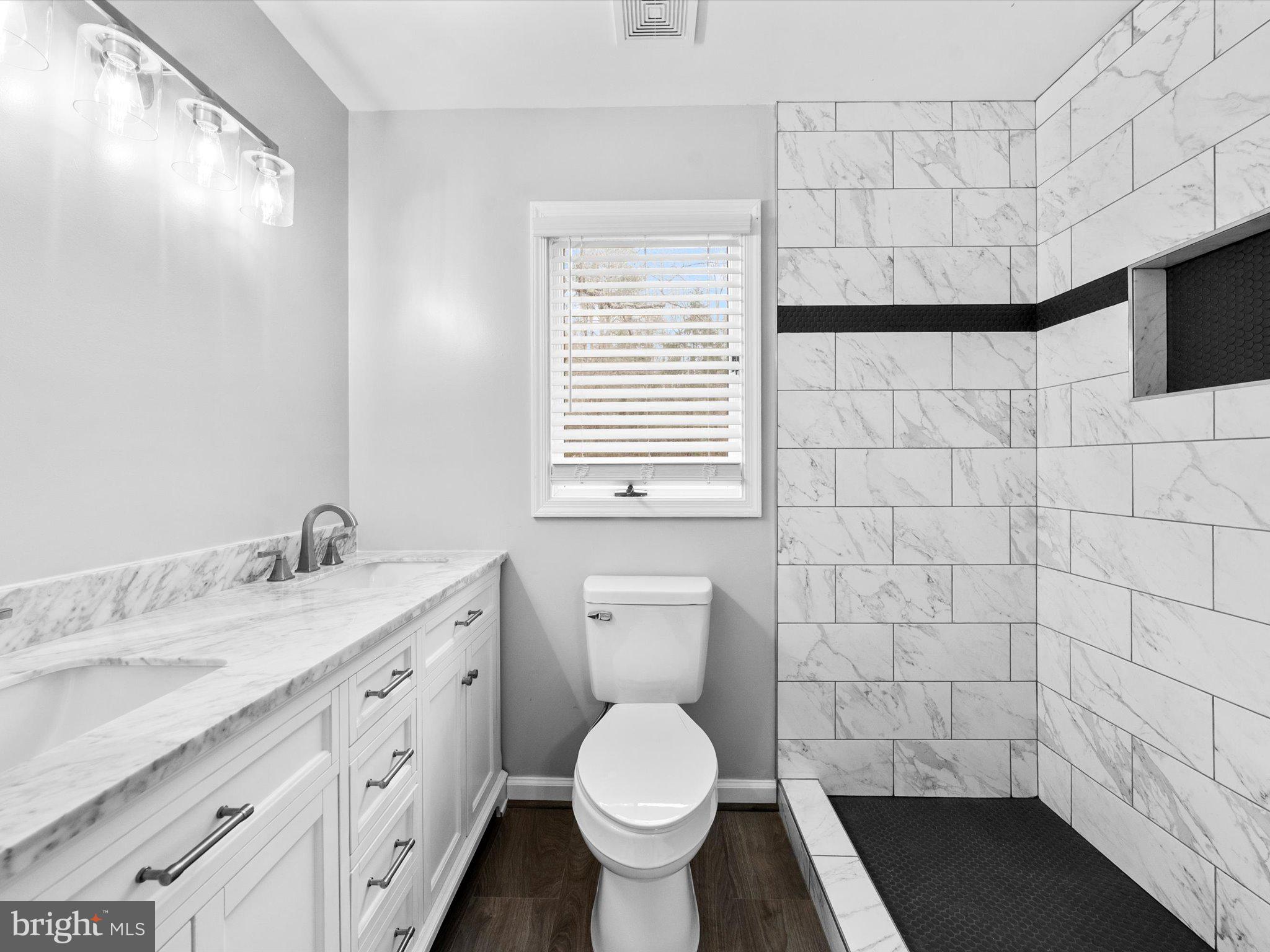 10009 River Road Petersburg, VA 23803 - Photo 31 of 59 a bathroom with a granite countertop toilet sink and mirror