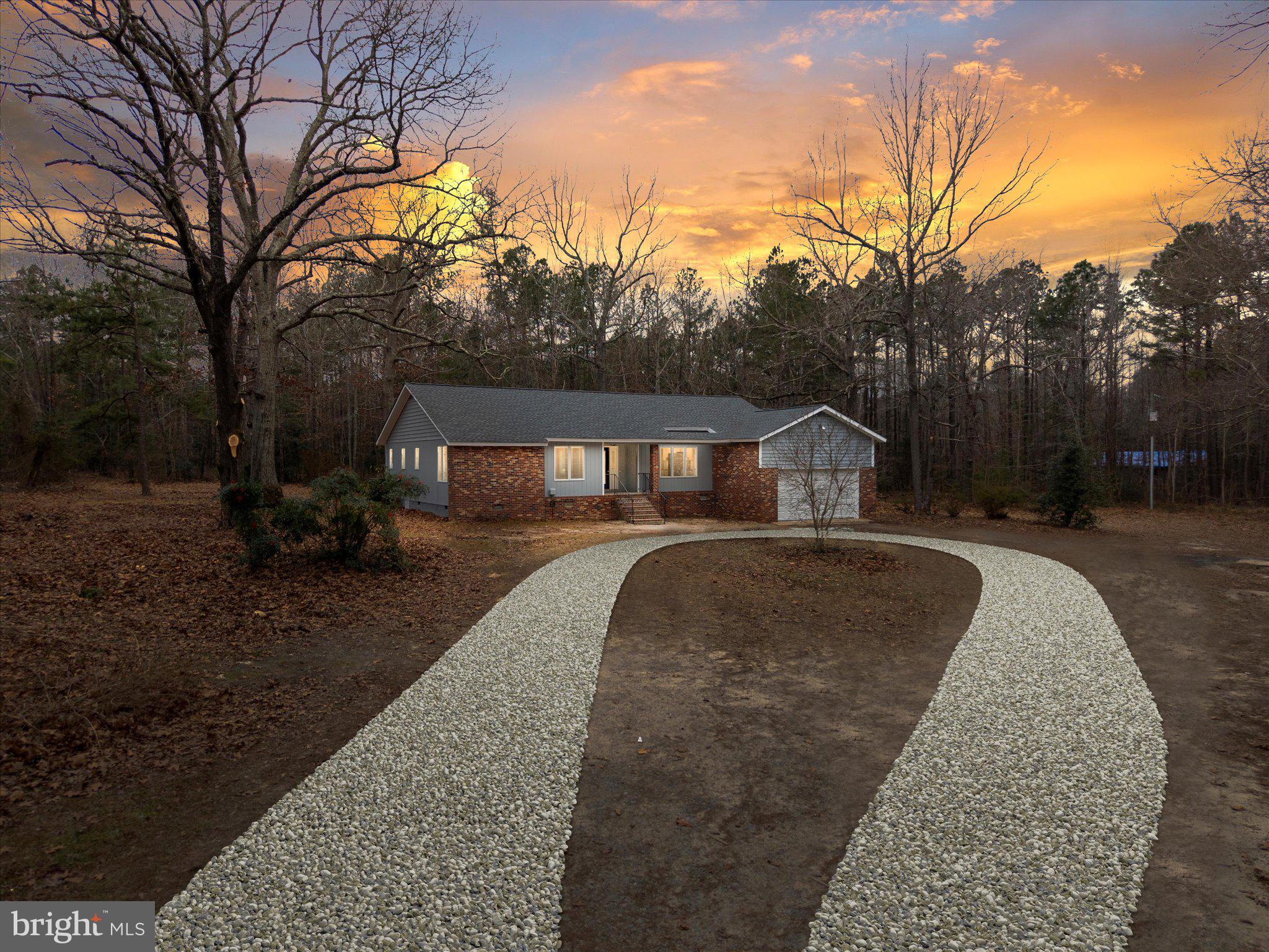 10009 River Road Petersburg, VA 23803 - Photo 49 of 59 a front view of house with yard and trees in the background