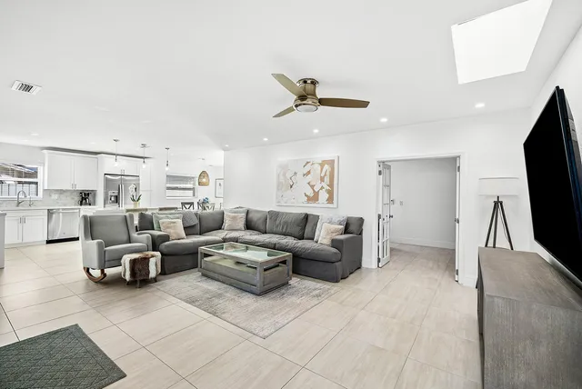 a living room with couches and a flat screen tv