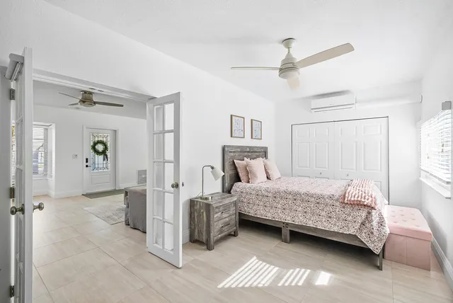 a bedroom with a bed and a chandelier