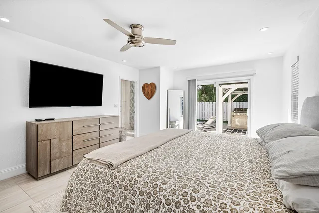 a bedroom with a bed and a flat screen tv