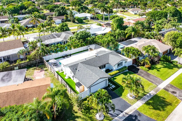 an aerial view of residential houses with outdoor space and parking