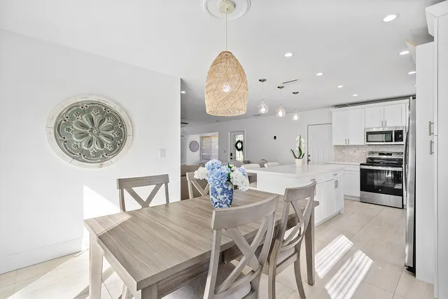 a dining room with furniture and a kitchen view