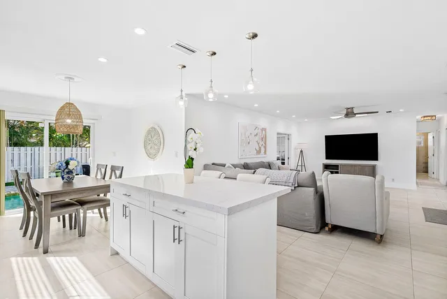 a living room with furniture a flat screen tv and a large window