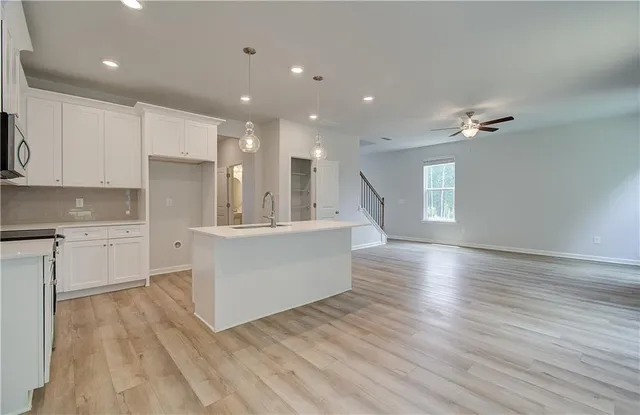 a view of kitchen with cabinets and wooden floor